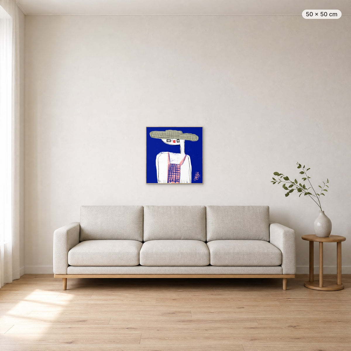 Emma canvas print in oak floating frame, 50 × 50 cm, shown above a 220 cm sofa