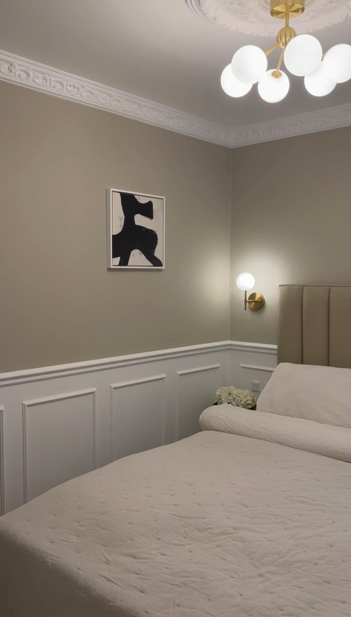 Black abstract Jacob Lund print above a bed in a customer's bedroom