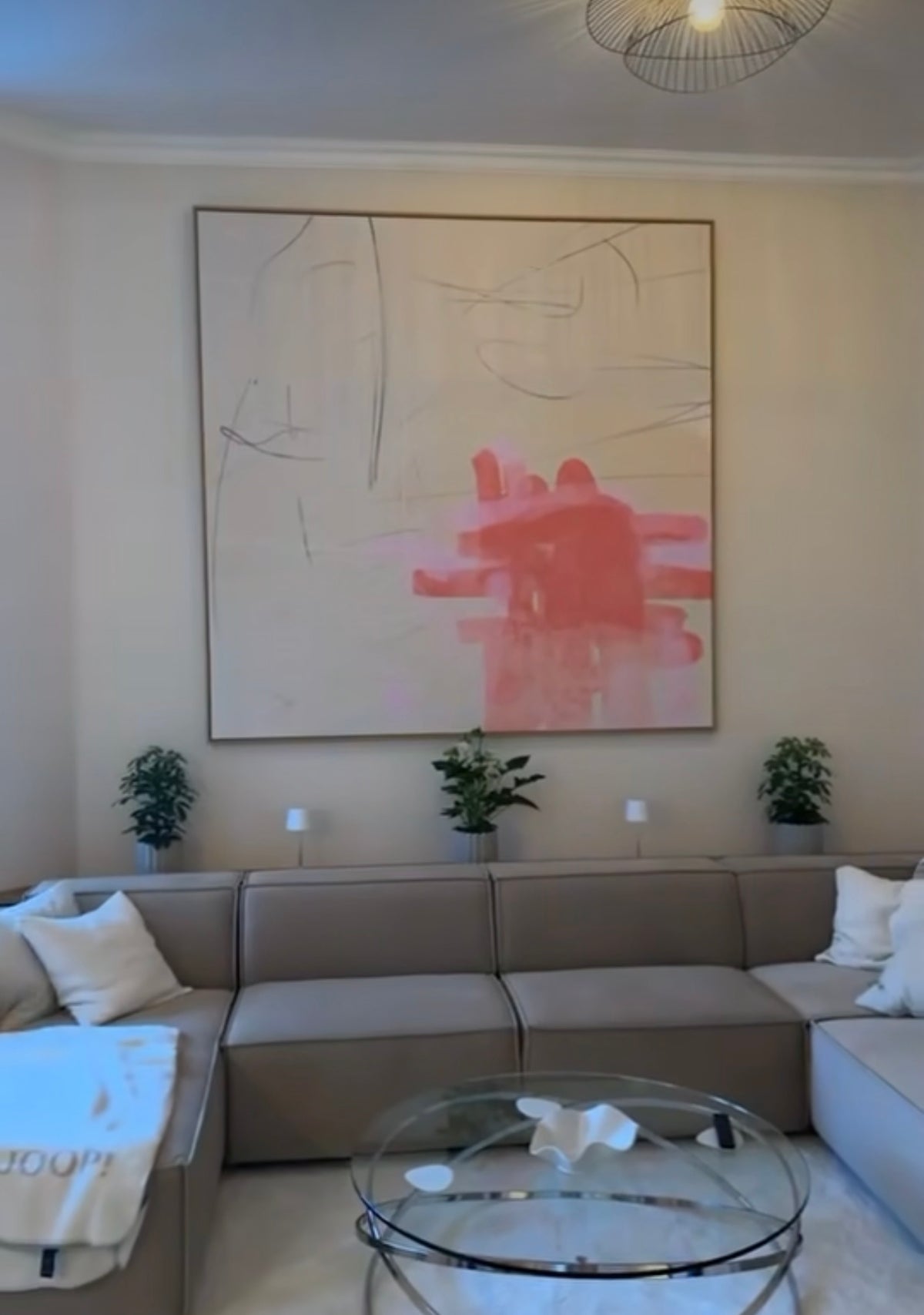 Pink abstract canvas by Jacob Lund above a grey sofa in a customer's living room