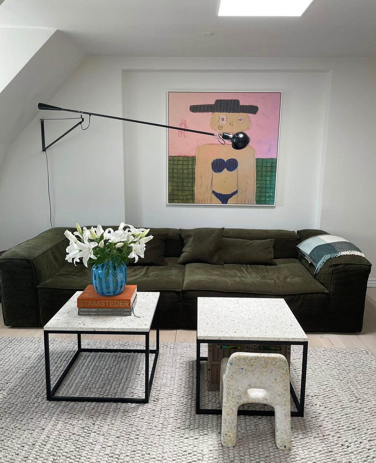 Jacob Lund portrait canvas above a dark sofa in a customer's living room