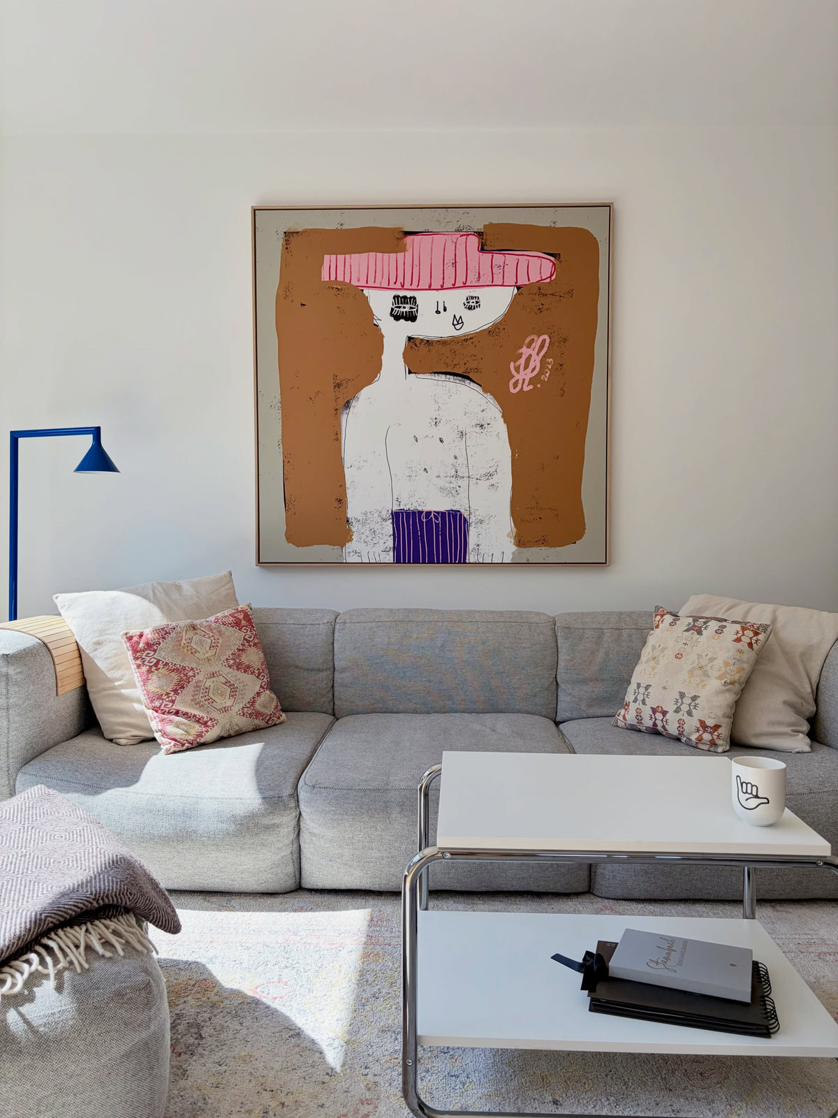 Jacob Lund Be Yourself portrait in an oak frame above a grey sofa in a customer's living room