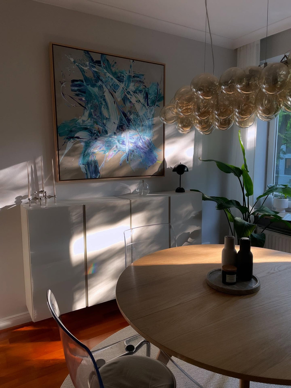Blue abstract canvas by Jacob Lund above a sideboard in a customer's dining room