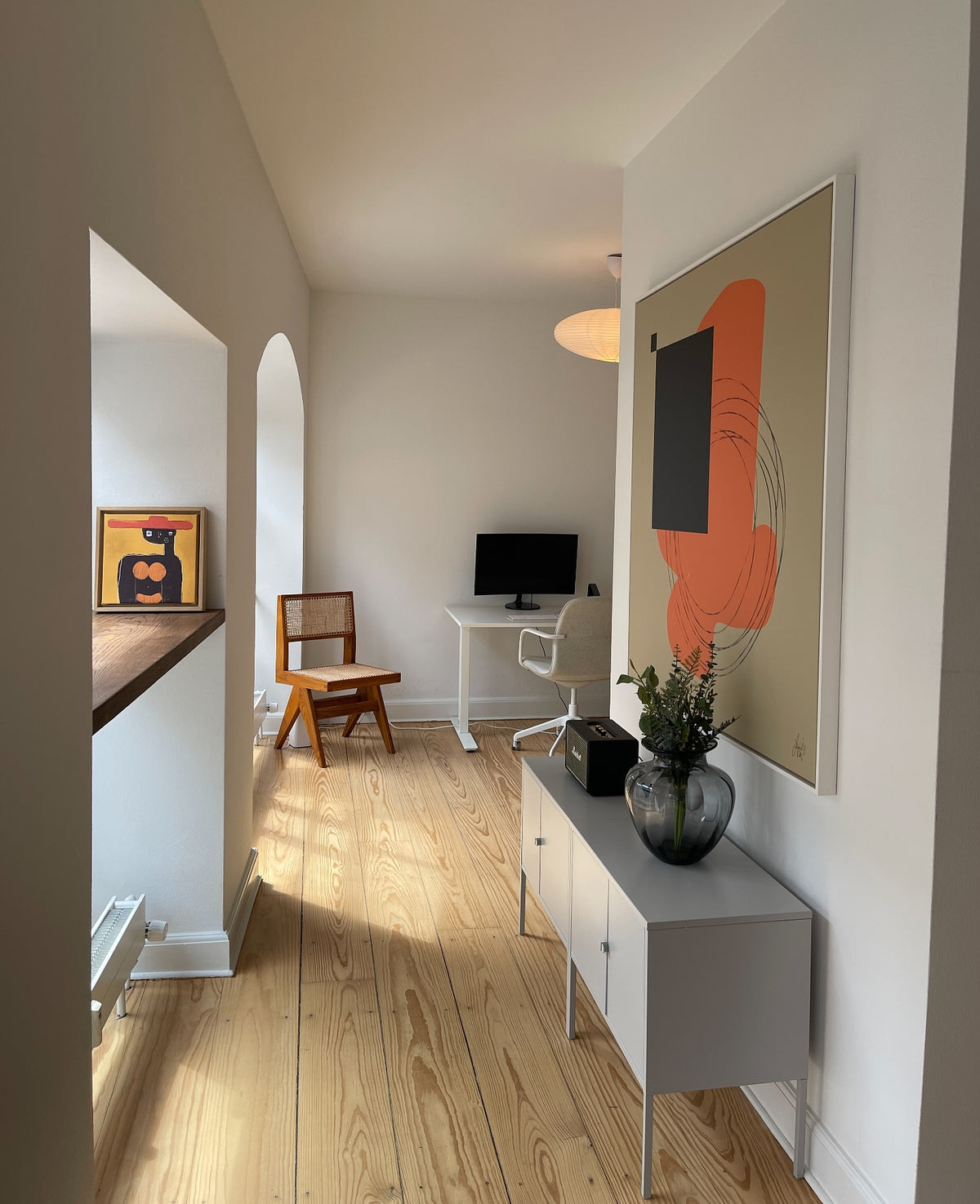 Orange and black abstract canvas by Jacob Lund in a customer's hallway