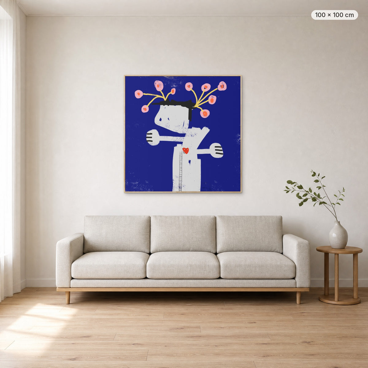 What We Water Grows canvas print in oak floating frame, 100 × 100 cm, shown above a 220 cm sofa